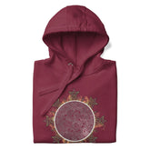 A folded maroon Xigfireon graphic hoodie featuring the Eclipsed iteration of the `Morning Star Fire` Celtic knot design, inspired by the 2023 Annular Solar Eclipse.