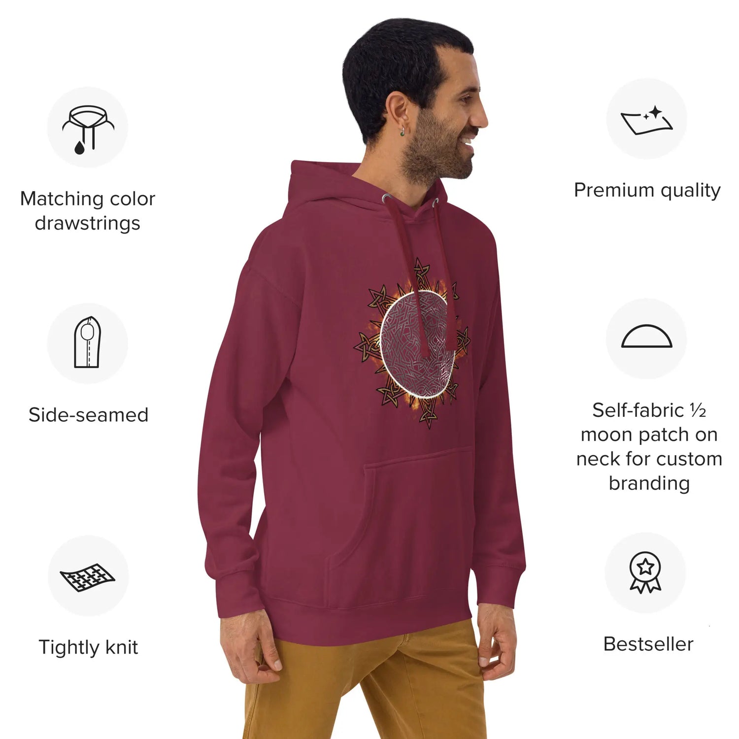 A young man wearing a maroon Xigfireon graphic hoodie featuring the Eclipsed iteration of the `Morning Star Fire` Celtic knot design, inspired by the 2023 Annular Solar Eclipse, with a series of product specs listed on either side. The products specs include Matching color drawstrings, Side-seamed, Tightly knit, Premium quality, Self-fabric half moon patch on neck for custom branding, and Bestseller.