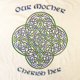 A close up of a white Xigfireon graphic t-shirt featuring the Living Colour iteration of the `Reach Of The Spirit` Celtic knot design along with a message in a Celtic font: "Our Mother, Cherish Her".