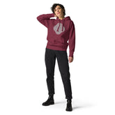 A young woman wearing a maroon Xigfireon graphic hoodie featuring the Black & White Hollow iteration of the `Reach Of The Spirit` Celtic knot design. The `Reach Of The Spirit` Celtic knot symbolizes the Earth.