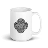 A Xigfireon white glossy 15oz mug featuring the Black & White Solid iteration of the `Reach Of The Spirit` Celtic knot design. This Celtic knot symbolizes Mother Earth.