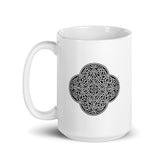 A Xigfireon white glossy 15oz mug featuring the Black & White Solid iteration of the `Reach Of The Spirit` Celtic knot design. This Celtic knot symbolizes Mother Earth.