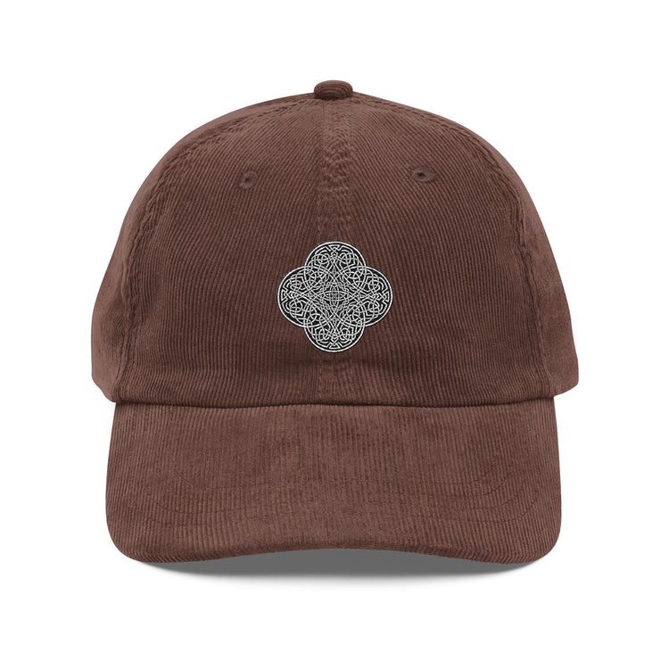 The front side of a brown Xigfireon vintage corduroy cap embroidered with the Black & White Solid iteration of the `Reach Of The Spirit` Celtic knot design.