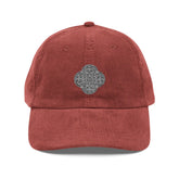 The front side of a burgundy Xigfireon vintage corduroy cap embroidered with the Black & White solid iteration of the `Reach Of The Spirit` Celtic knot design.