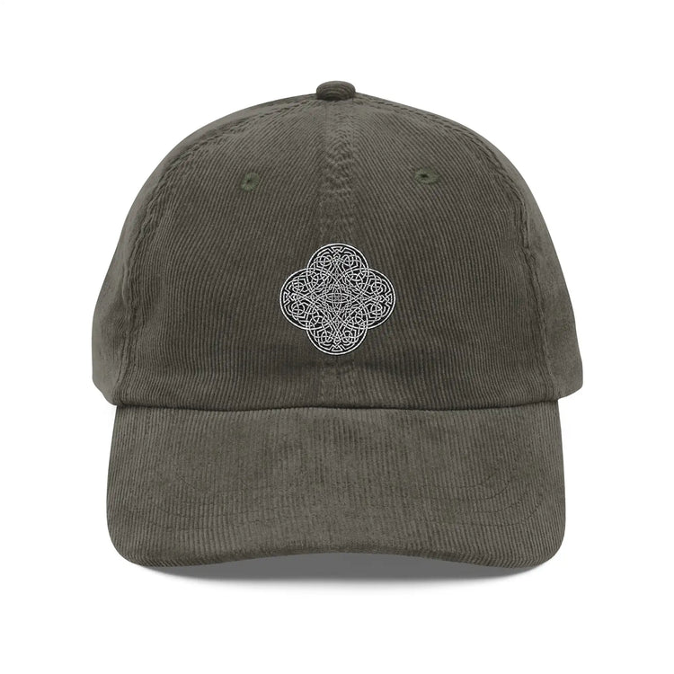 The front side of an olive green Xigfireon vintage corduroy cap embroidered with the Black & White Solid iteration of the `Reach Of The Spirit` Celtic knot design.