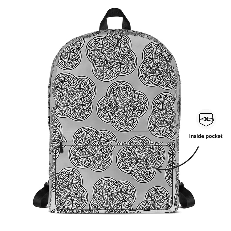 A view of the back of a Xigfireon backpack featuring the Black & White Solid Forest Inverted iteration of the `Reach Of The Spirit` Celtic knot pattern. A simple graphic and arrow indicate the location of the inside pocket.