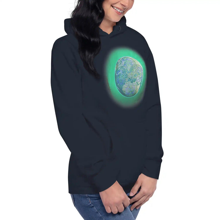 A young woman wearing navy blazer blue Xigfireon graphic hoodie featuring the Deep Forest iteration of the `Reach Of The Spirit` Celtic knot design.