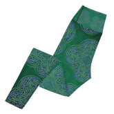 The left side of a folded pair of Xigfireon graphic yoga leggings featuring the Living Colour Forest patterned series of the `Reach Of The Spirit` Celtic knot design.