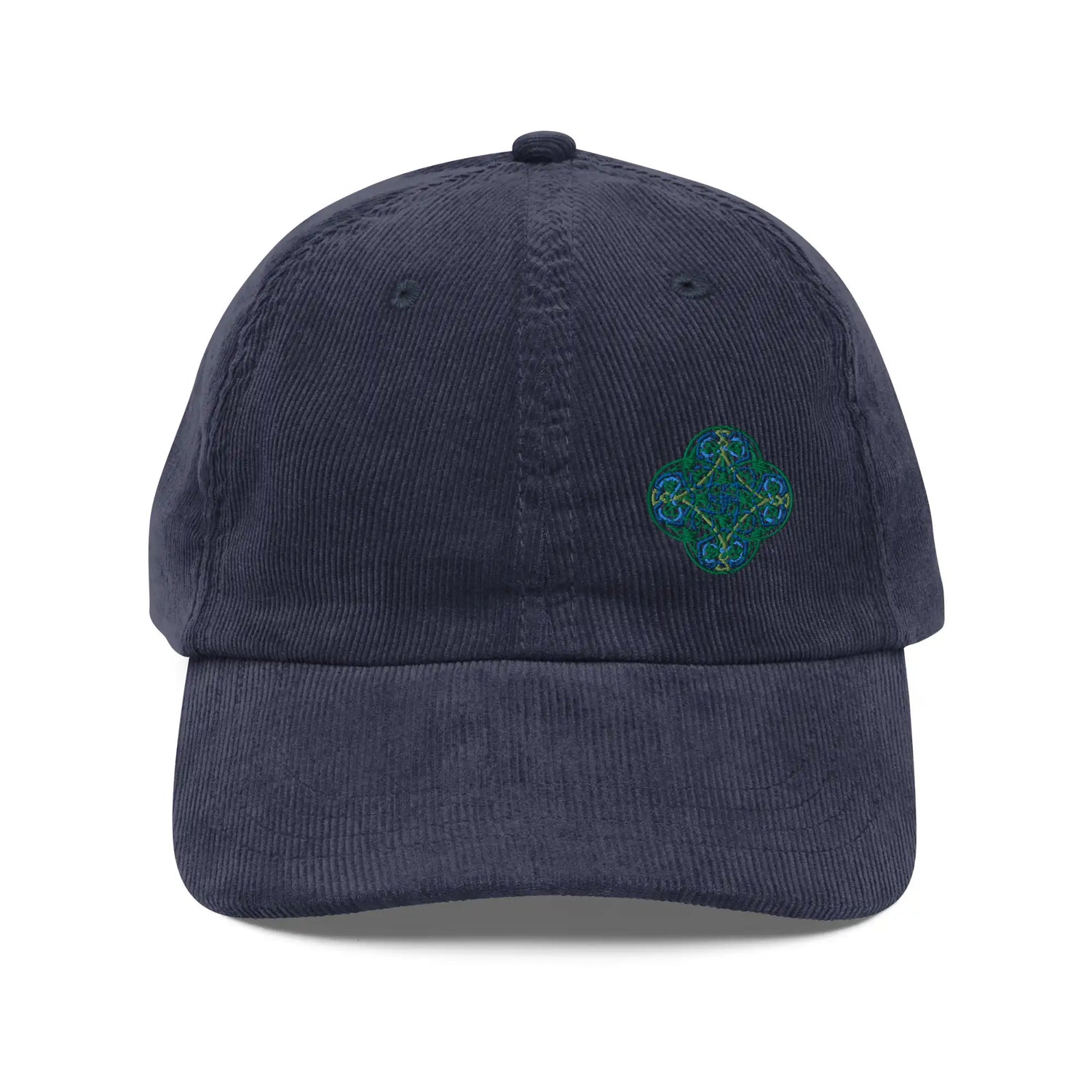 The front side of a navy blue Xigfireon vintage corduroy cap embroidered with the Living Colour iteration of the `Reach Of The Spirit` Celtic knot design offset to the left.