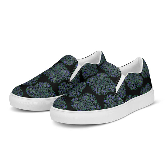 A pair of Xigfireon canvas slip-on shoes featuring the Living Colour on Black iteration of the `Reach Of The Spirit` Celtic knot pattern. The `Reach Of The Spirit` Celtic knot represents the Earth.