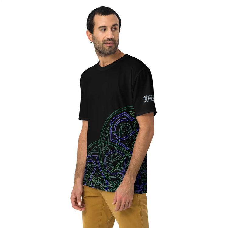 A young man wearing a black Xigfireon graphic mens t-shirt featuring the Living Colour Outline iteration of the `Reach Of The Spirit` Celtic knot design.