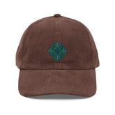 The front side of a brown Xigfireon vintage corduroy cap embroidered with the Living Colour iteration of the `Reach Of The Spirit` Celtic knot design.