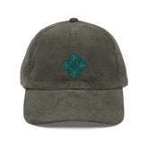 The front side of an olive green Xigfireon vintage corduroy cap embroidered with the Living Colour iteration of the `Reach Of The Spirit` Celtic knot design.