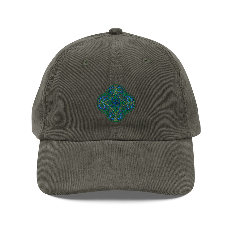 The front side of an olive green Xigfireon vintage corduroy cap embroidered with the Living Colour iteration of the `Reach Of The Spirit` Celtic knot design.