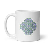 A Xigfireon white ceramic 11oz mug featuring the Living Colour iteration of the `Reach Of The Spirit` Celtic knot design. This Celtic knot symbolizes Mother Earth.