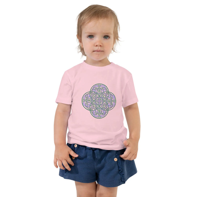 A young girl shown wearing a pink Xigfireon toddler graphic t-shirt featuring the Living Colour iteration of the `Reach Of The Spirit` Celtic knot design. The `Reach Of The Spirit` Celtic knot symbolizes the Earth.