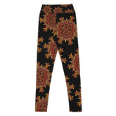 The back side of a pair of Xigfireon graphic yoga leggings featuring the Fire Colour Black patterned series of the Morning Star Fire Celtic knot design.
