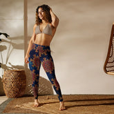 A woman in a studio wearing a pair of Xigfireon graphic yoga leggings featuring the Fire Colour Cosmos patterned series of the Morning Star Fire Celtic knot design.