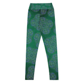 The back side of a folded pair of Xigfireon graphic yoga leggings featuring the Living Colour Forest patterned series of the Reach Of The Spirit Celtic knot design.