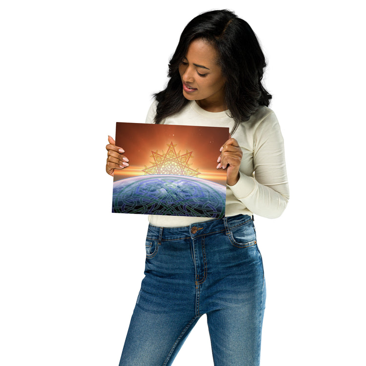 A young woman holding a Xigfireon 8 inch x 10 inch glossy metal print of the `Derivation II` Celtic knot design, which represents the Sun and the Earth in their cosmic dance.