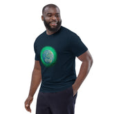 A young man wearing a French navy blue Xigfireon graphic organic cotton t-shirt featuring the Deep Forest iteration of the `Reach Of The Spirit` Celtic knot design. The `Reach Of The Spirit` Celtic knot represents the glorious Earth.