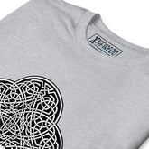 A close-up view of a sport grey Xigfireon graphic t-shirt featuring the Black & White Solid iteration of the `Reach Of The Spirit` Celtic knot design. The `Reach Of The Spirit` Celtic knot represents Mother Earth.