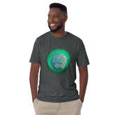 A young man wearing a dark heather Xigfireon graphic t-shirt featuring the Deep Forest iteration of the `Reach Of The Spirit` Celtic knot design. The `Reach Of The Spirit` Celtic knot represents Mother Earth.