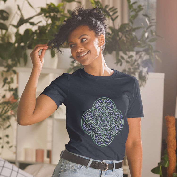 A young woman wearing a navy blue Xigfireon graphic t-shirt featuring the Living Colour iteration of the `Reach Of The Spirit` Celtic knot design. The `Reach Of The Spirit` Celtic knot symbolizes the Earth.